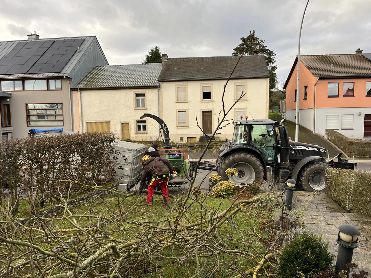 FEIERMAX tractor and chipper clearing branches during a land-clearing job